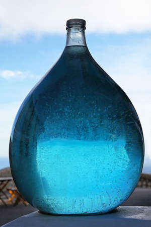 Blue aqua liquid in big glass bottleの写真素材