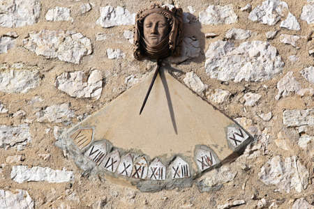 Sundial clock with Roman numbers at south wallの写真素材