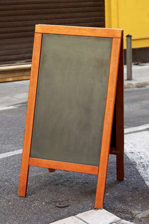 Empty black chalk board at pavement sidewalkの写真素材