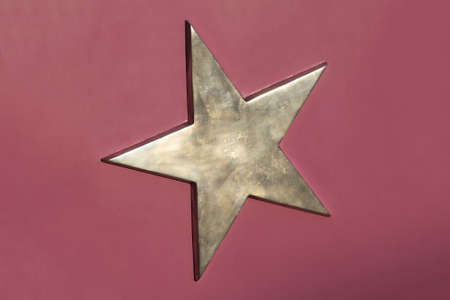 Goden 3d pentagram star at purple backgroundの写真素材