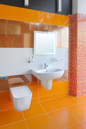 Contemporary bathroom interior with bright orange tilesの写真素材