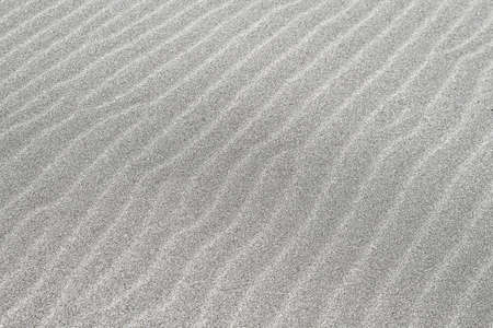 Granular grey sand dunes with diagonal patternの写真素材