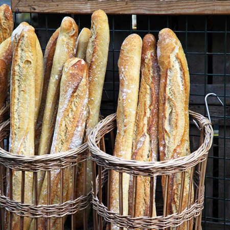Traditional crusty French baguette bread in basketsの写真素材
