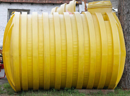 Plastic yellow storage tank for underground installationの写真素材