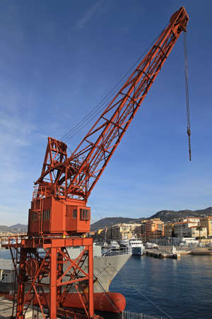 Old red crane in port of Niceの写真素材