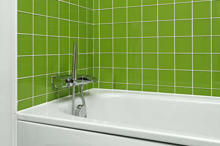 Bathtub with modern faucet in green bathroomの写真素材