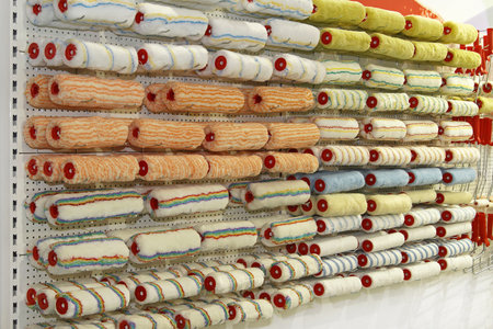 New paint rollers in all sizes and shapes at wall shelfの写真素材