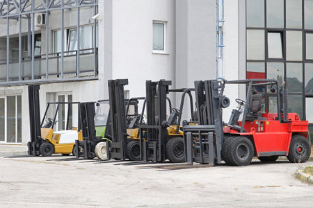 Forklift trucks in front of distribution warehouse
