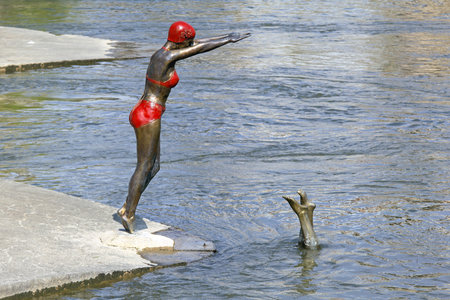 SKOPJE, MACEDONIA - SEPTEMBER 17: Swimmer statue in Skopje on SEPTEMBER 17, 2012. Bronze statue of swimmer woman in bikini at Vardar River in Skopje, Macedonia.のeditorial素材