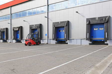 Forklift at loading ramp in distribution warehouse