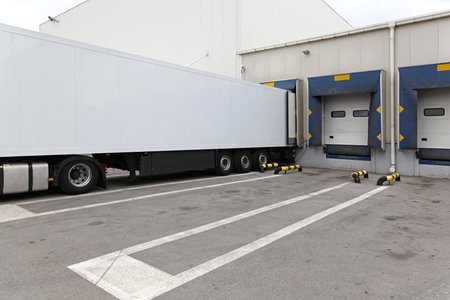 White box semi trailer at warehouse loading bay