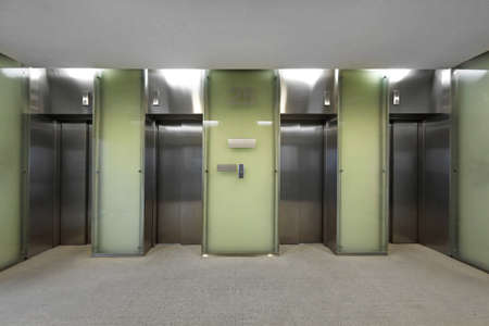 Hall with four elevators in business buildingの写真素材