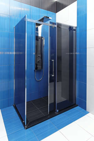 Contemporary glass shower cabin in blue bathroom