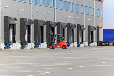 Forklift at loading ramp at distribution warehouseの写真素材