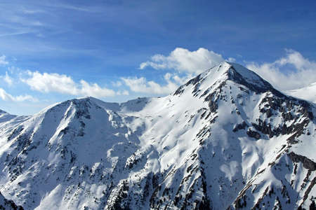Mountain peak covered in snow at winterの写真素材