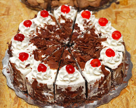 Whole cake with cherries on topの写真素材