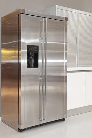 Big double fridge with ice maker in kitchenの写真素材