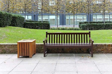 Empty wooden bench in city parkの写真素材