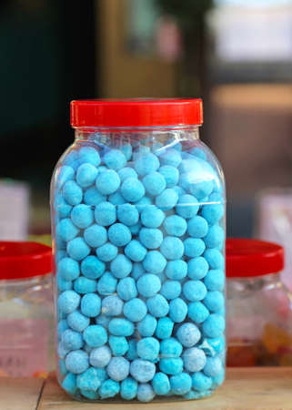 Big jar full of blue candy sweetsの写真素材