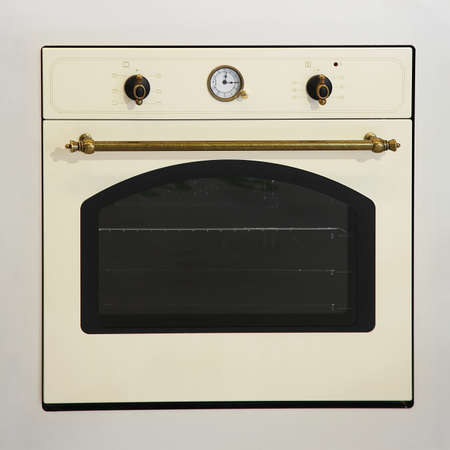 Retro style beige oven with brass detailsの写真素材