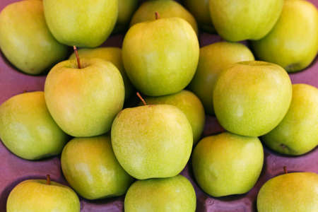 Bunch of ripe apples at market stallの写真素材