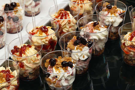 Sweets in cups at dessert buffet