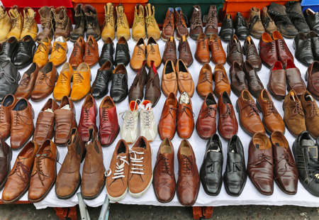 Big selection of second hand shoes at street flea market