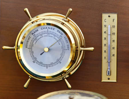 Retro style brass barometer and thermomether weather stationの写真素材