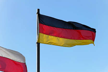 The flag of Germany tricolour flying at windの写真素材