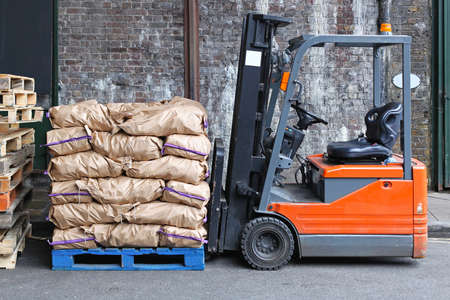 Pallet forklift carrying sacks of potatoesの写真素材
