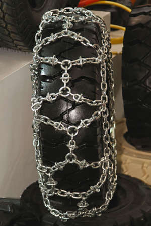 Snow chains fitted to tire for winter