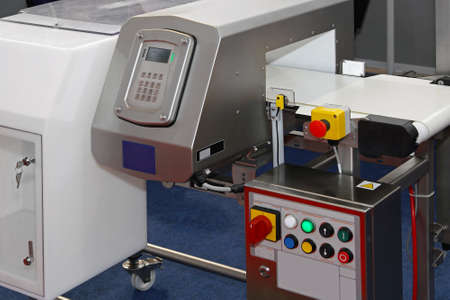 Metal detector at production line in food factory