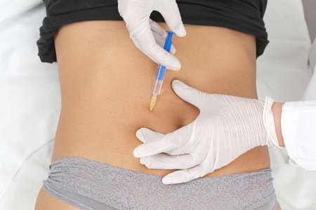 Woman having botox treatment at beauty clinic