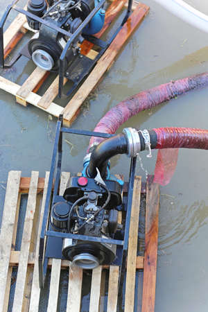 Water pumps at pallets pumping out floodsの写真素材