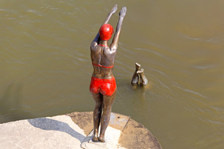 SKOPJE, MACEDONIA - SEPTEMBER 17  Swimmer statue in Skopje on SEPTEMBER 17, 2012  Bronze statue of swimmer woman in bikini at Vardar River in Skopje, Macedonia のeditorial素材