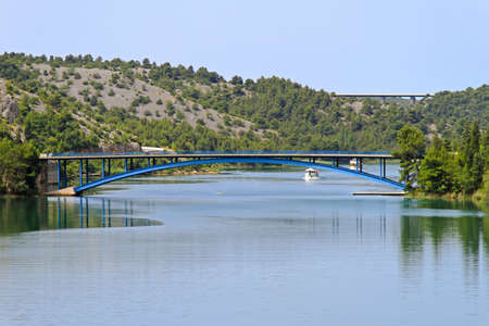 Arch bridge over Krka river in Croatiaの写真素材