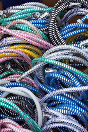 Bunch of plastic and chrome shower hosesの写真素材
