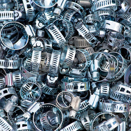 Big pile of bolt band clamps partsの写真素材