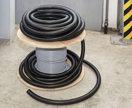 Cable coil and plastic hose for electric installation