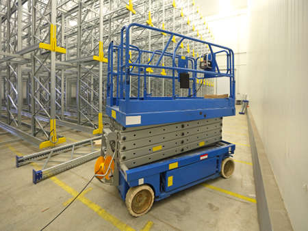 Scissor lift aerial work platform in warehouse