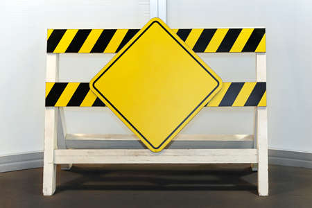 Blank yellow sign at construction barrier