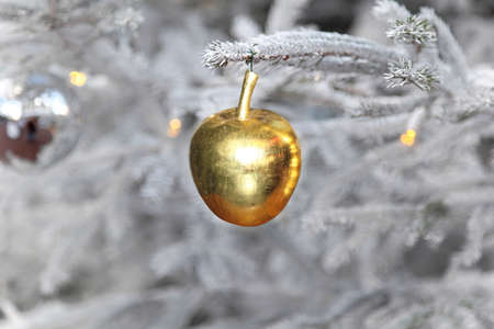 Gold apple ornament at Christmas treeの写真素材