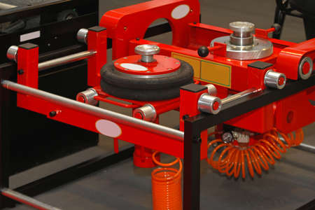 Pneumatic air lift jack in auto service garageの写真素材