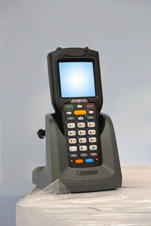 Handheld laser barcode scanner reader at charger dock
