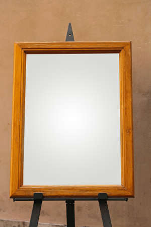 Empty picture frame on art easel holder