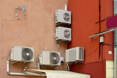 External compressor units of air conditioners at building wallの写真素材