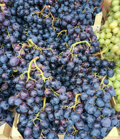 Big bunch of grapes in crates at market