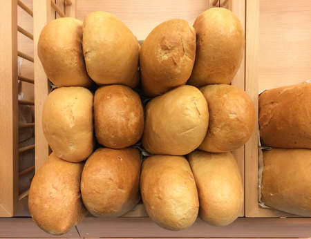 Pile of white bread loaf in bakery shelfの素材