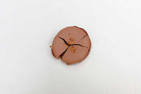 One crushed and cracked chocolate macaron