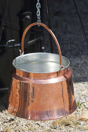 Hanging Copper Pot for Cooking at Open Flameの写真素材